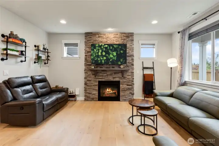 Gorgeous and light wide plank engineered hardwood floors and beautiful gas fireplace.