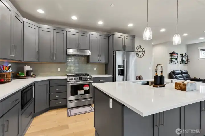 Another look at this fantastic kitchen with quartz countertops and counter to cabinet backsplash.