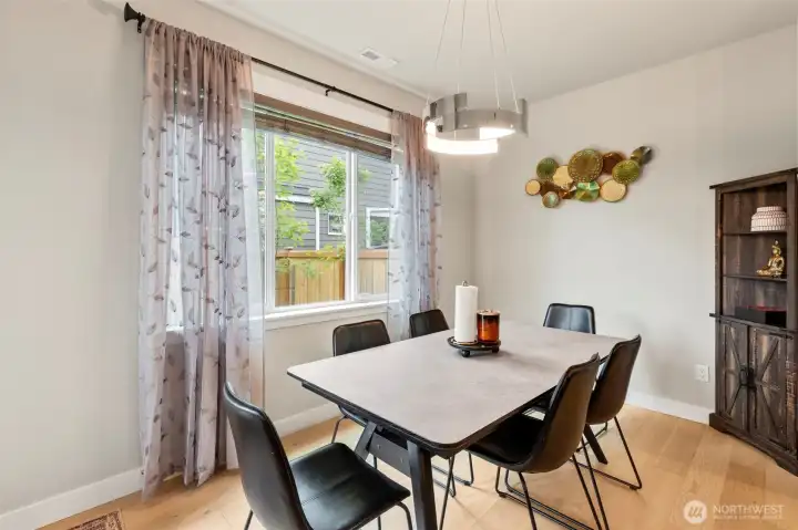 Another view of the dining area offers views of the backyard.
