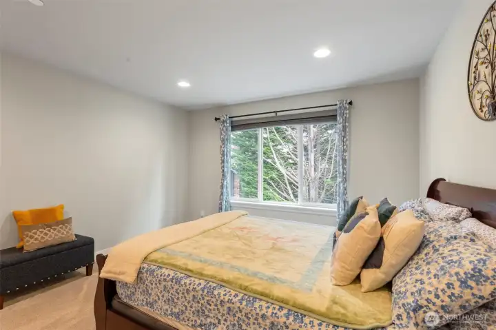 Another view of the second bedroom with large window looking out to the front of the house.