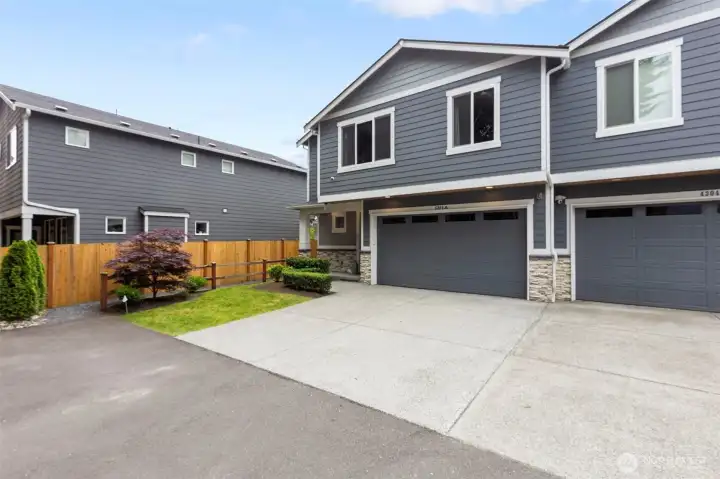 Front view of the home with covered front porch and 2-car garage.