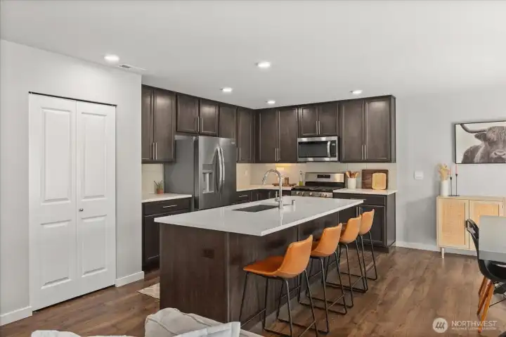 Built in pantry with full shelving. Also view of full backsplash. Built in pantry with full shelving. Also view of full backsplash.