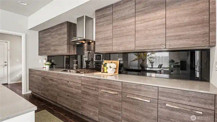 The chef-inspired kitchen features stainless steel appliances, rich dark cabinetry, and recessed lighting. The chef-inspired kitchen features stainless steel appliances, rich dark cabinetry, and recessed lighting.