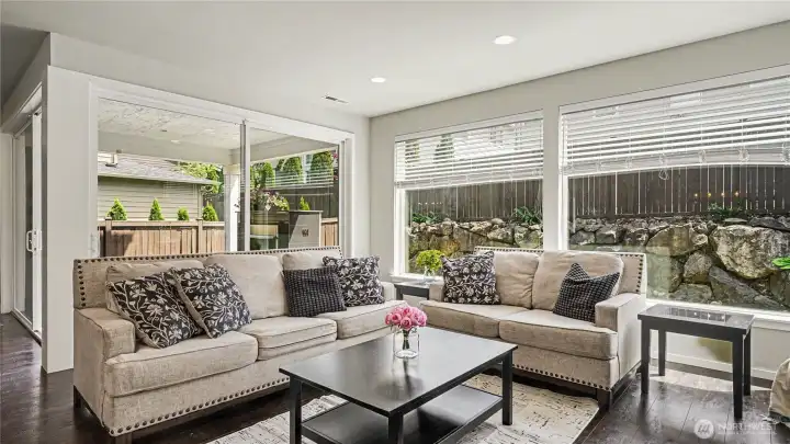 Living room is surrounded by large windows, filling the space with natural light and bringing the outdoors in. Living room is surrounded by large windows, filling the space with natural light and bringing the outdoors in.