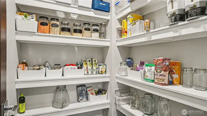 Generous walk-in pantry offering abundant storage and organization. Generous walk-in pantry offering abundant storage and organization.