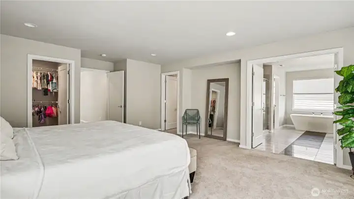 Relax in the spacious primary suite featuring two walk-in closets and a private en-suite bathroom. Relax in the spacious primary suite featuring two walk-in closets and a private en-suite bathroom.