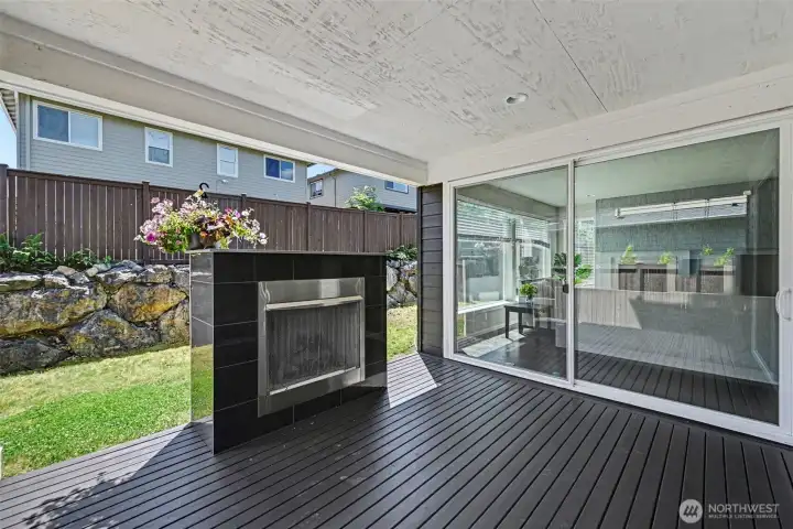 Beautiful covered deck featuring a cozy fireplace and convenient access through two large sliding glass doors. Beautiful covered deck featuring a cozy fireplace and convenient access through two large sliding glass doors.