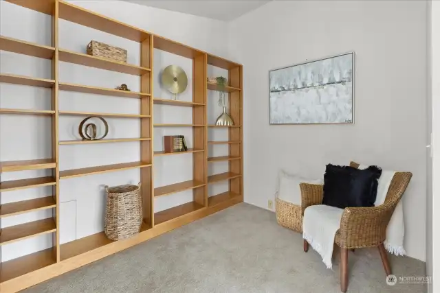 Additional work or creative space off of the Livingroom. Solid and adjustable shelving.