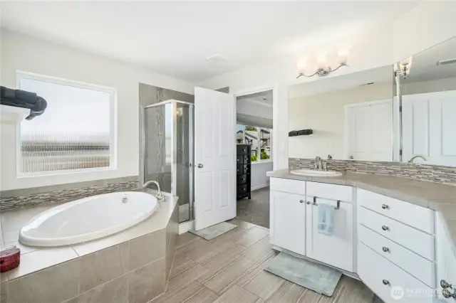 Primary suite bathroom with soaking tub, walk-in shower, double sinks and walk-in closet.