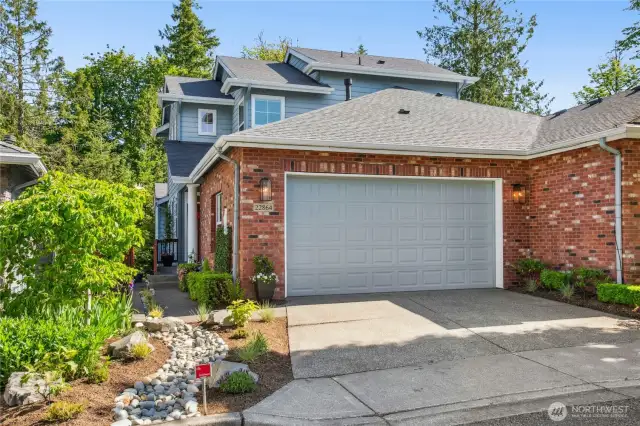 Beautiful brick accents and impeccable landscaping. Plenty of parking in front of the two car garage.
