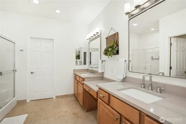 The premiere bath features two vanities, quartz countertops ,ceramic floors, new fixtures, and lighting