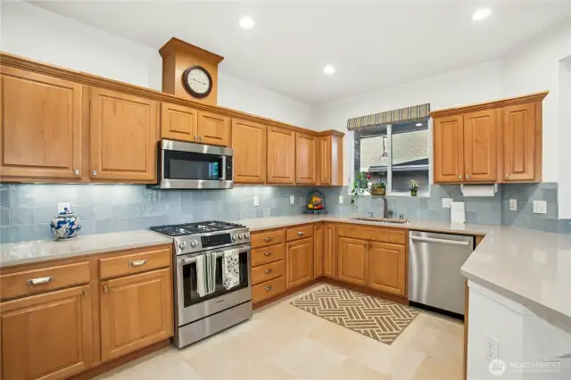 The remodeled kitchen features, new appliances, quartz countertops, tile backsplash, new sink and faucet