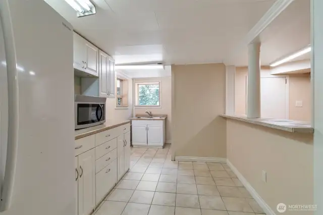 Second kitchen area downstairs with sink and laundry area