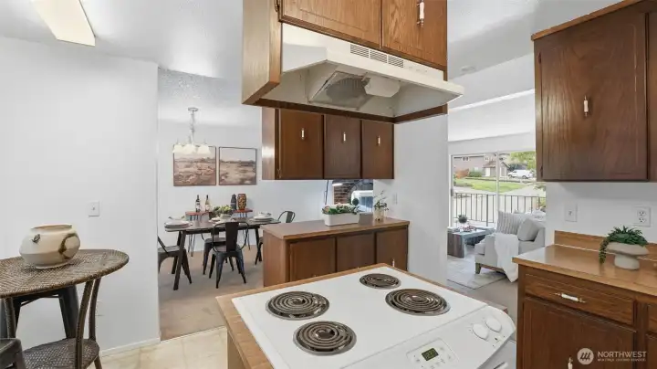Kitchen with pass-through to dining and living rooms offers bright, connected main-level living.