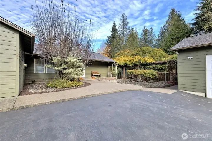 Such a lovely entrance...Notice the arbor on the right - wisteria and roses!