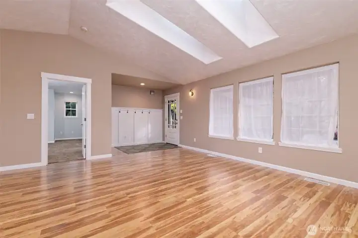 Beautiful big living room with LPV flooring. That's the Primary bedroom off to the left.