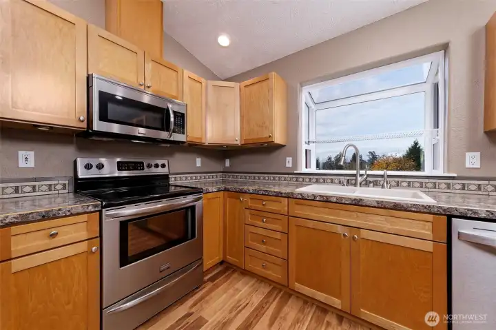Beautiful kitchen with a sunny window to enjoy the view of the water and mountains.