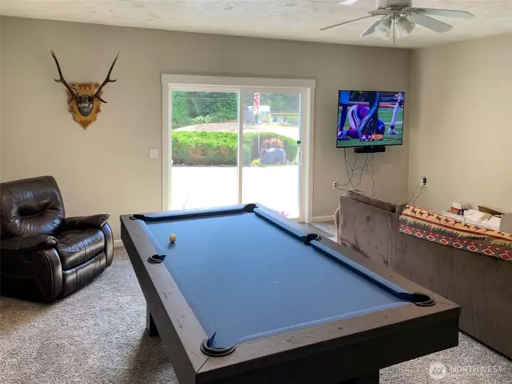 This is the giant rec room with a slider to the front of the house and driveway.