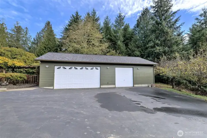 Large 3-bay garage. Inside there is a full wall that separates the 2-bay side from the 1-bay side. And the shared well is in its own room off of the back that has its own man door with a separate key so both well parties can access it if they need to.