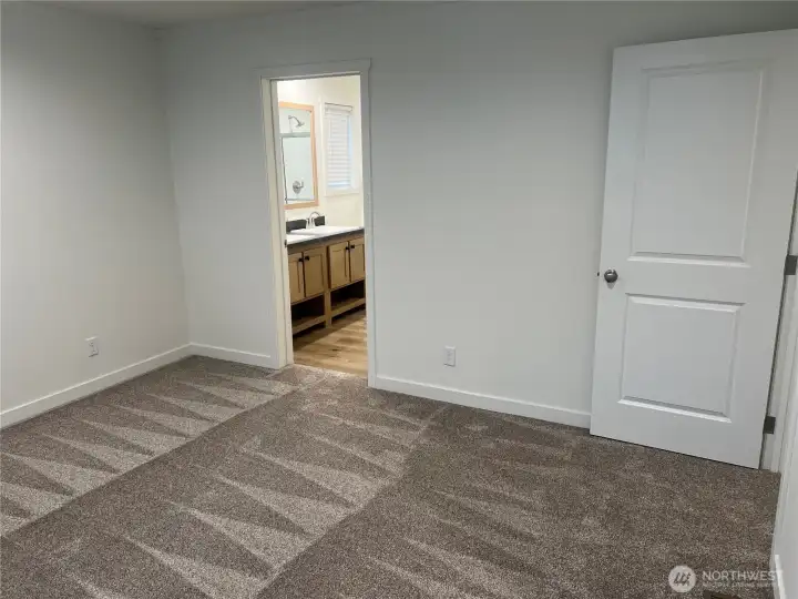 Primary bedroom looking into bathroom.