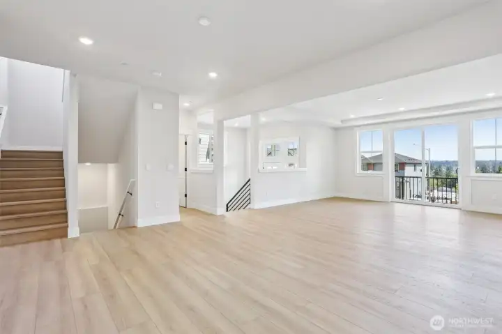 Expansive great room/dining room area with access to east facing deck.  Photo is of similar home-details & finishes will vary-ask site agent for details