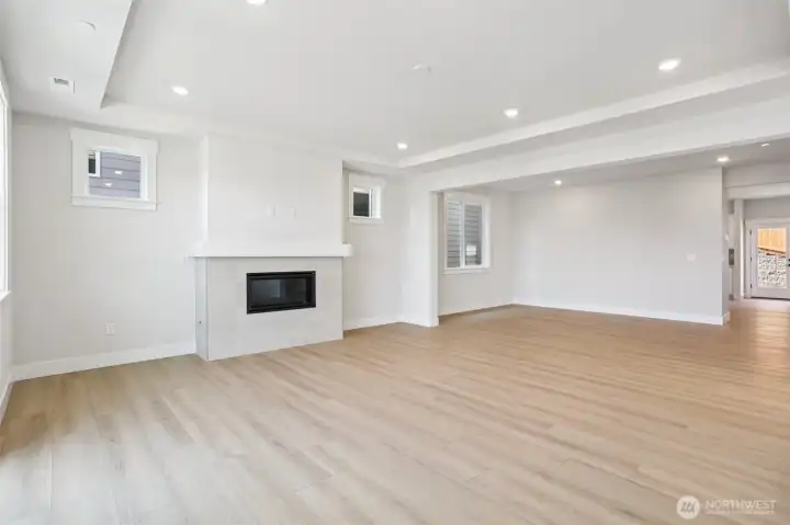 Great room/dining room warmed by a gas fireplace.  Photo is of similar home-details & finishes will vary-ask site agent for details