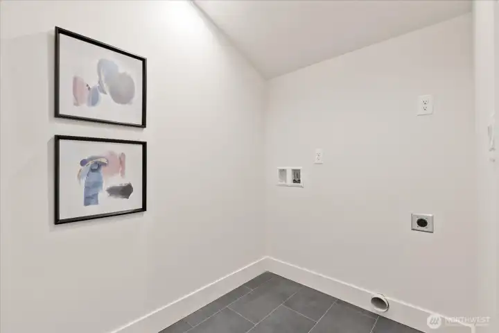 Oversized laundry room upstairs for added convenience.
