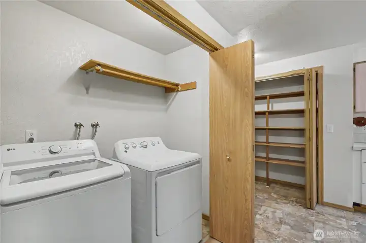 View of your utility room in hall off of kitchen, included washer and dryer and handy light and fan.