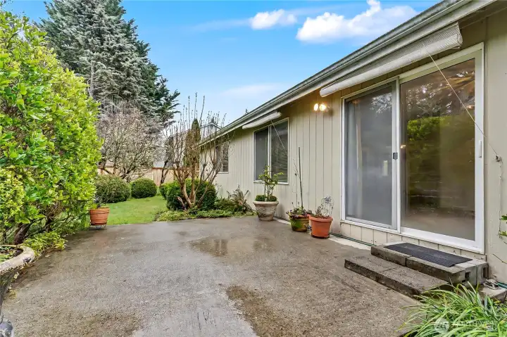 View of your patio and backyard. Fully fenced, quiet and peaceful, love all the bird songs! Awnings you can lower on really sunny days as well.