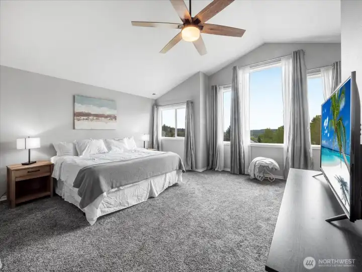 Primary bedroom has a gas fireplace, space for a king size bed, and sitting space.