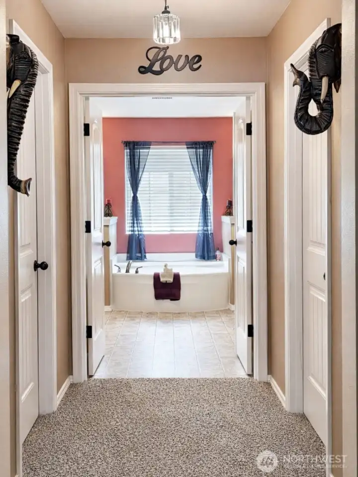 Primary En-suite entry #1 hallway with walk in closets on each side
