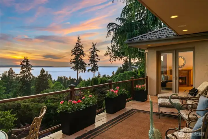 The expansive view deck creates an unforgettable setting for year-round indoor-outdoor living, perfectly positioned to capture sweeping vistas of Puget Sound, the Olympic Mountains, and spectacular Northwest sunsets. Whether enjoying a quiet morning coffee or evening entertaining under the glow of the sunset sky, this beautifully designed outdoor space offers warmth, privacy, and breathtaking natural beauty.