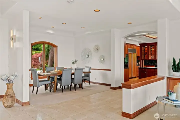 Elegant and welcoming, the formal dining room offers a beautiful setting for both intimate dinners and larger gatherings. Expansive windows bring in natural light and frame peaceful views of the surrounding landscape, while rich millwork and timeless architectural details add warmth and sophistication. Thoughtfully positioned near the kitchen and main living spaces, this inviting room was designed for effortless entertaining and memorable occasions.