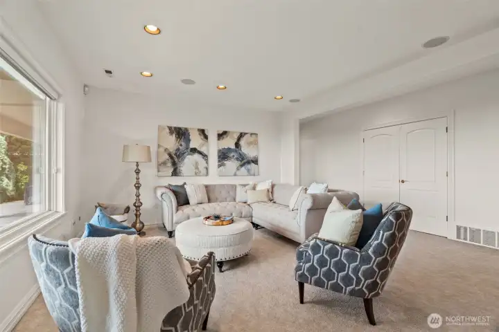 Spacious and versatile, the lower level rec room offers the perfect setting for movie nights, game days, or relaxed gatherings with friends and family. Soft natural light, generous proportions, and comfortable living space create an inviting atmosphere designed for both recreation and everyday living. Thoughtfully positioned near additional bedrooms and guest spaces, this flexible retreat is ideal for multigenerational living, entertaining, or a private getaway within the home.
