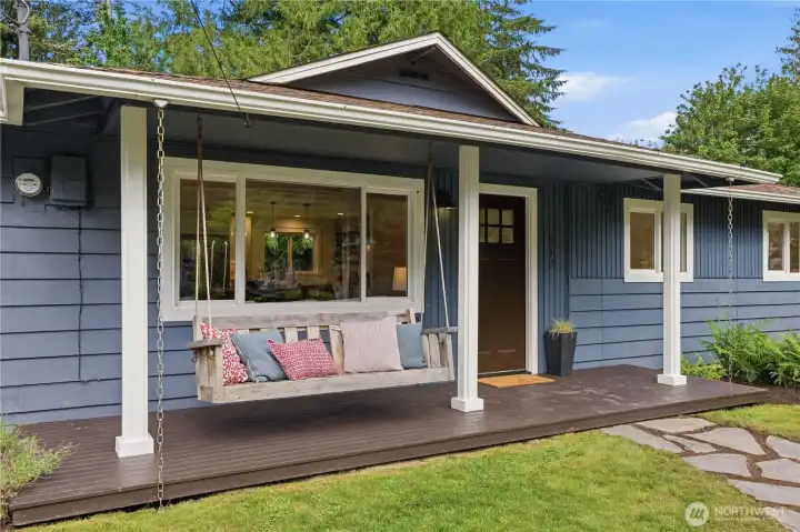 Charming oversized covered front porch featuring a porch swing, stunning views, and inviting curb appeal.