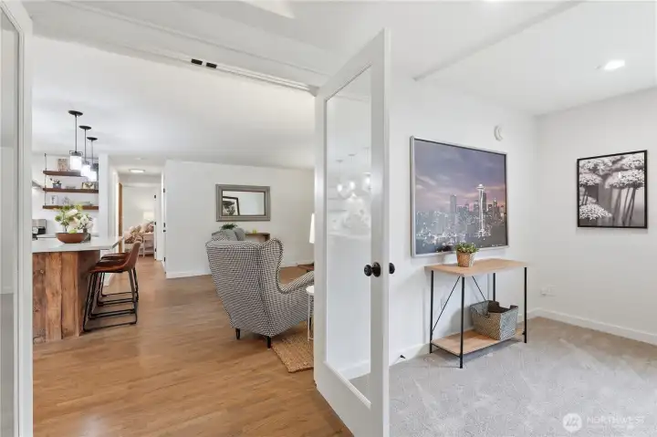 On the opposite end of the home, French doors lead to a versatile bonus room, laundry area, and dedicated office space.