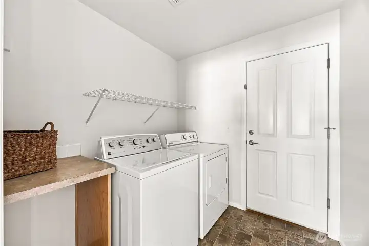 Laundry Room off the Kitchen w/ access to the Garage.