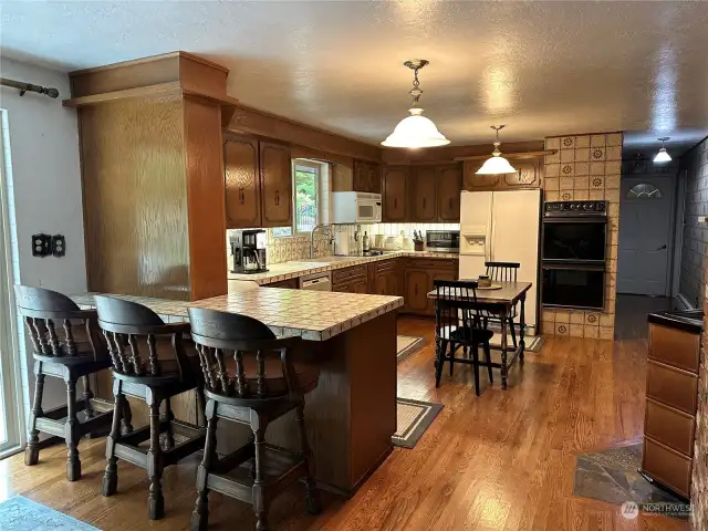 The bar in the kitchen is a bonus area for eating, the small wood stove heats this area nicely during the cold weather months.