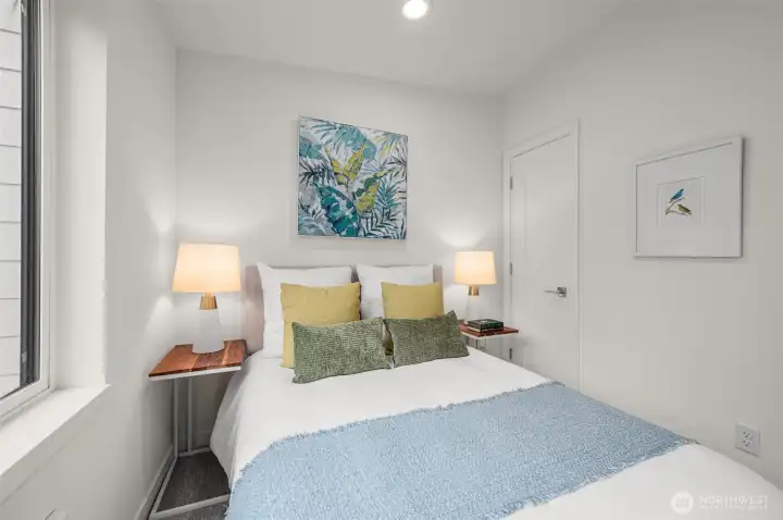 Photos of model home with similar finishes & floor plan. Another angle of the second bedroom shows a space-saving design and modern simplicity that feels instantly welcoming.