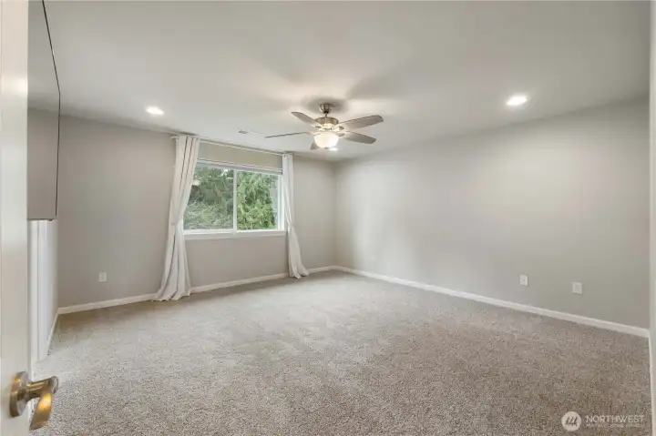 Primary bedroom faces green space.