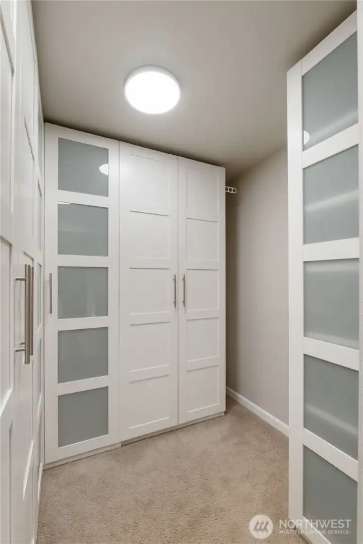 primary closet with storage units.