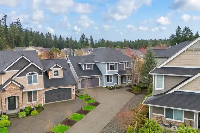 Nestled in a friendly cul-de-sac, this home features a spacious driveway, manicured landscaping, and a classic PNW architectural style.