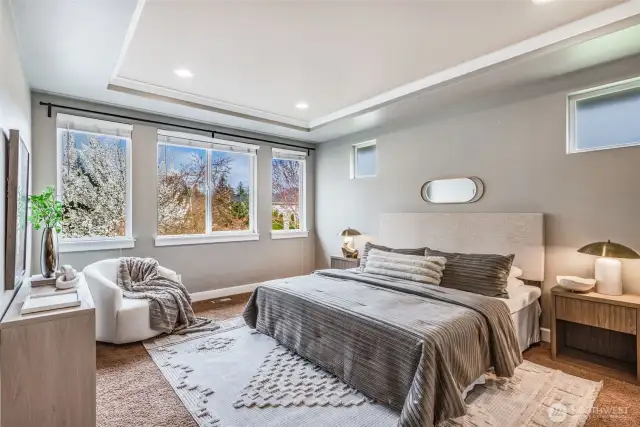 Bathed in natural light, this elegant Primary Suite offers a peaceful retreat with coffered ceilings, serene views, and a layout designed for ultimate comfort.
