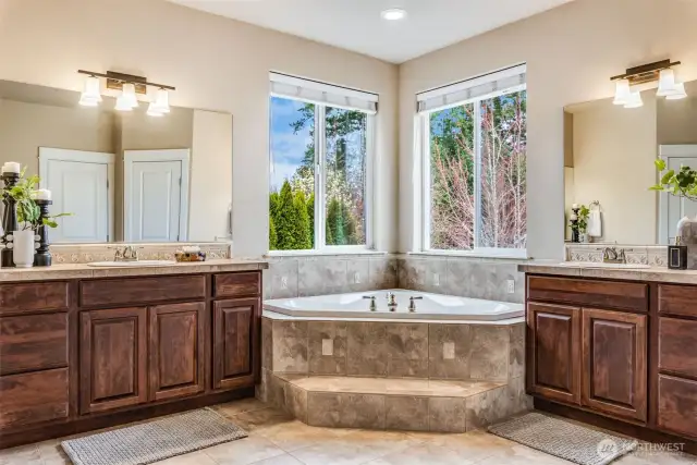 A spa-worthy escape right at home—this luxe ensuite features separate dual vanities, a soaking tub with a view, and all the natural light your morning routine deserves.