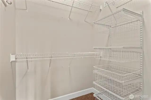 Dual walk-in closets featuring built-in drawers, open shelving, and generous hanging space—designed to keep everything perfectly in place and effortlessly organized.