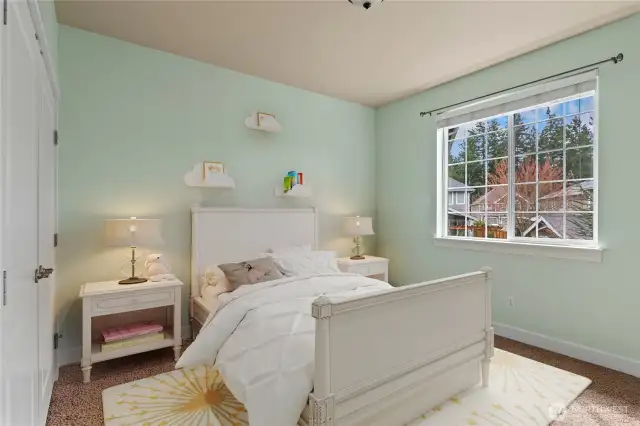 Third bedroom with plush carpet and a spacious double-door closet.   Photo virtually staged