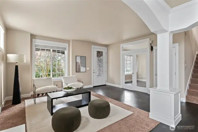 Charming front formal living room offers a cozy retreat with abundant natural light and flexible use options.