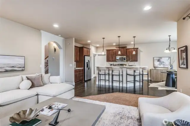 Light-filled living area with large windows and neutral tones creates a warm, inviting space.