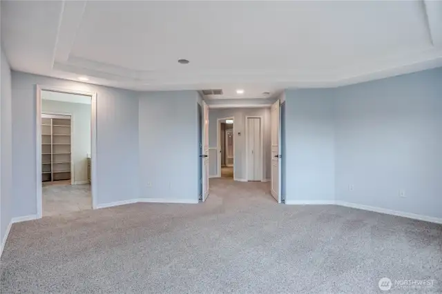 Large Primary Bedroom looking towards spa-like bathroom and French entry doors