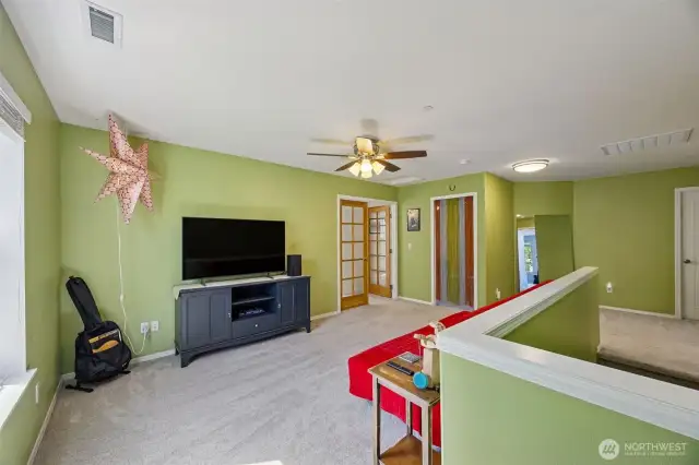Spacious bonus loft with ceiling fan and large stoarage closet.